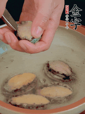 鮑魚加鹽、清水浸泡，用勺子挖出鮑魚肉。